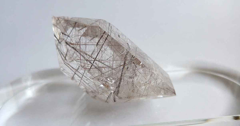 Polished Reclining Silver and Brass Rutile Point